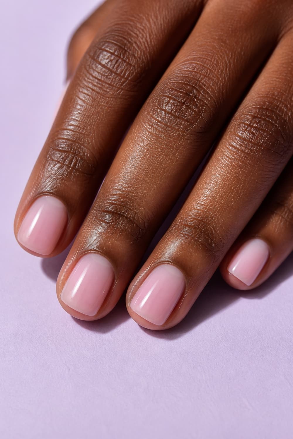 Short squoval nails with a translucent milky pink gloss for a practical school-day manicure