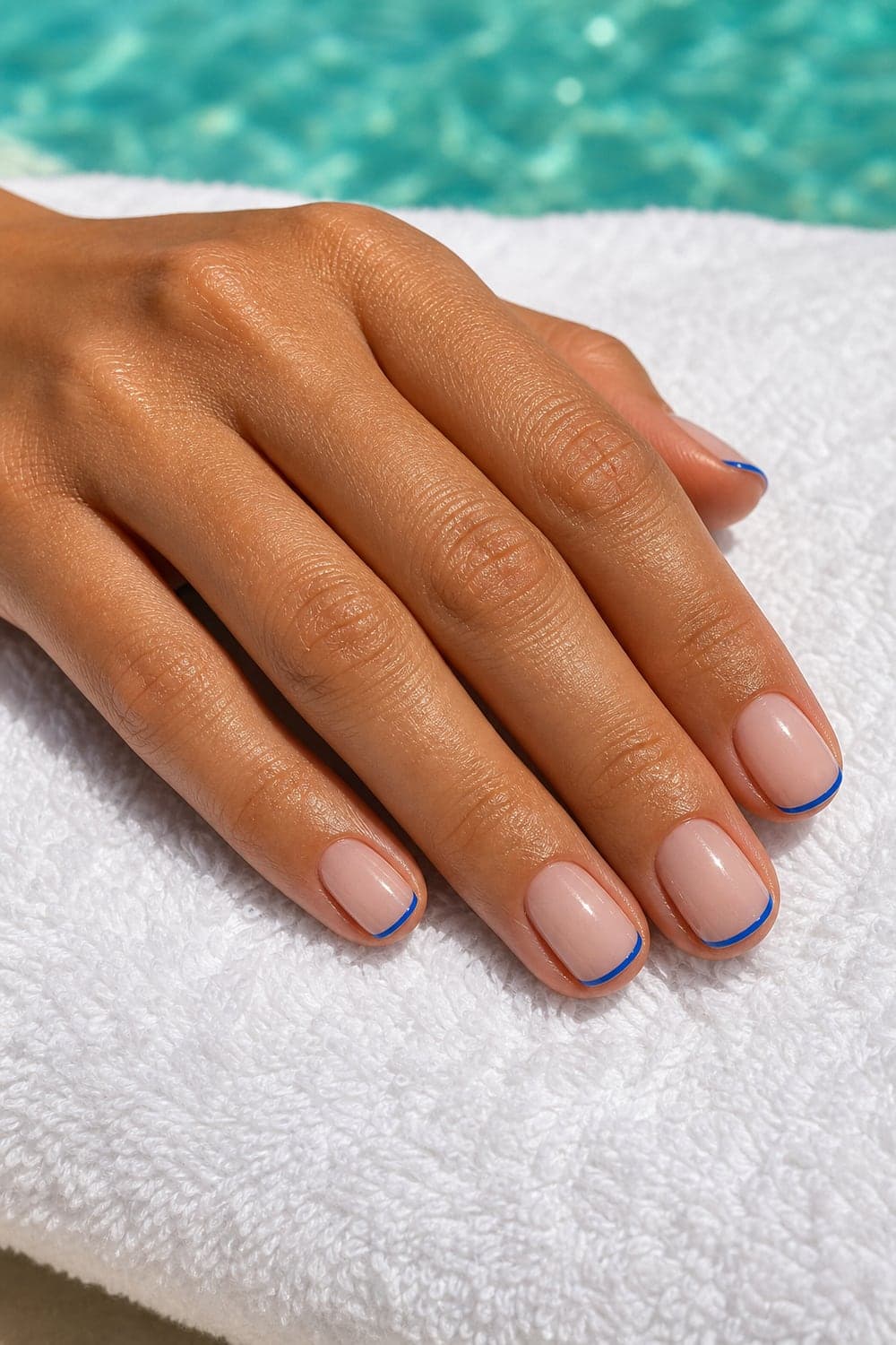 Beach vacation nails with ocean blue tips for summer