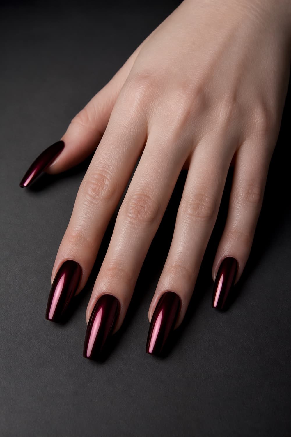 Long coffin nails with a dark oxblood chrome finish for Halloween