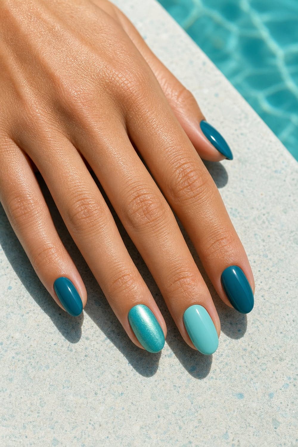 Teal nails close up on female hand
