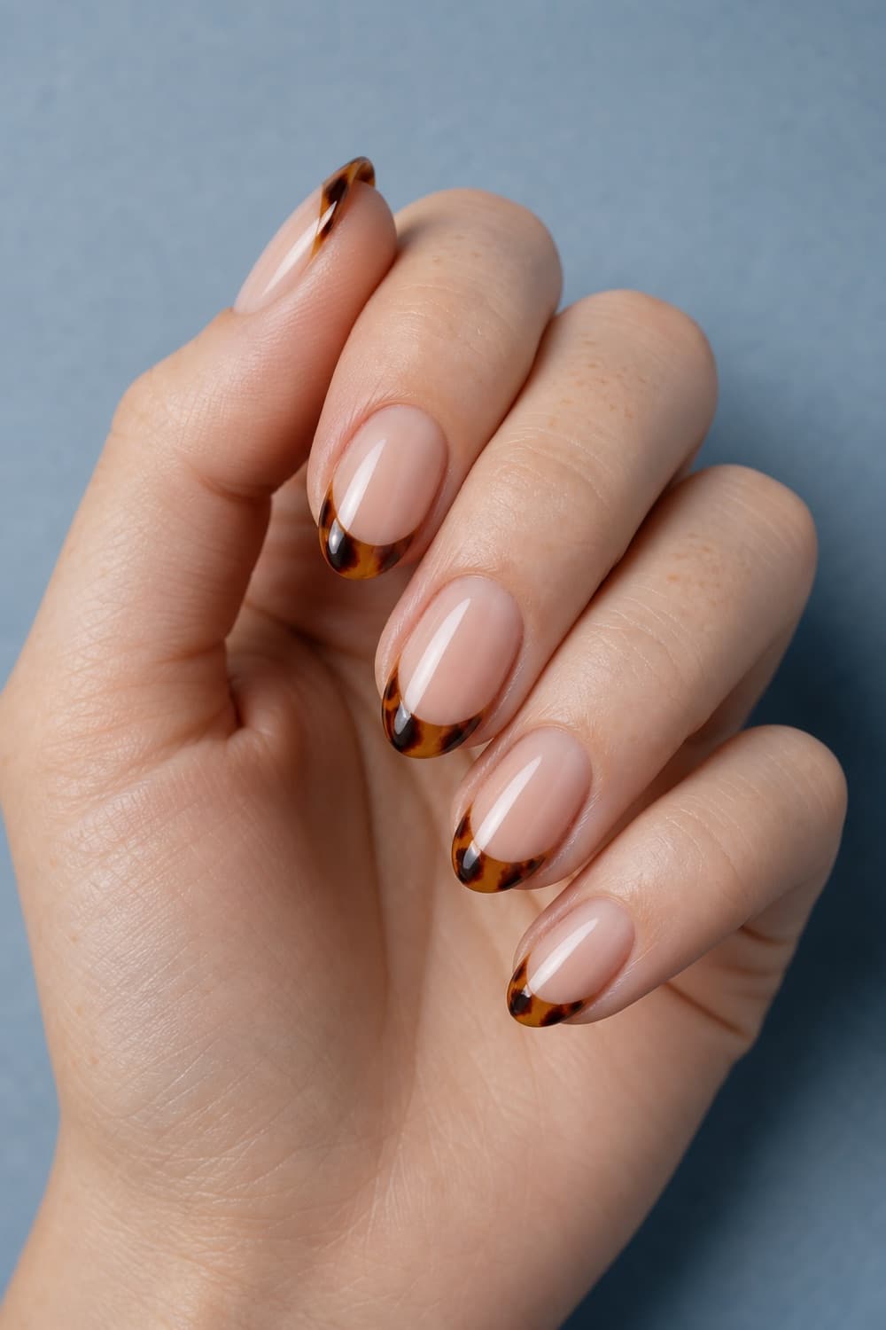 Short almond nails with translucent amber tortoiseshell French tips for Friendsgiving